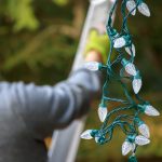 Man,In,Gray,Holding,Christmas,Lights,Climbs,Ladder