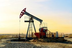 Crude,Oil,Pump,Jack,At,Oilfield,On,Sunset,Backround.,Fossil